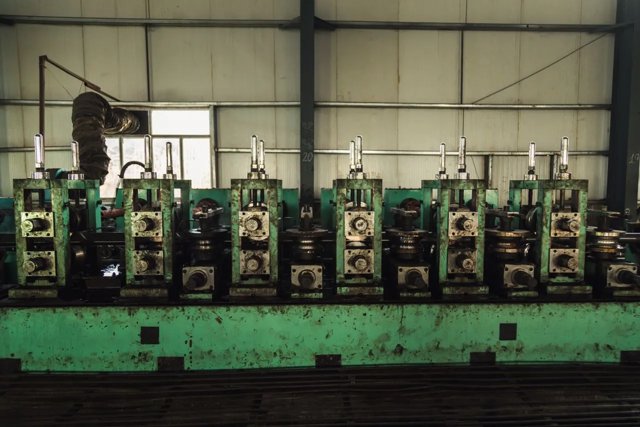 Row of green industrial machines with control levers in different positions